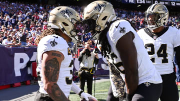 Oct 8, 2023; Foxborough, Massachusetts, USA; New Orleans Saints safety Tyrann Mathieu (32) reacts with linebacker Demario Davis (56) after scoring a touchdown against the New England Patriots during the first half at Gillette Stadium. Mandatory Credit: Brian Fluharty-USA TODAY Sports