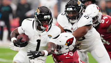 Arizona Cardinals defensive lineman Dante Stills (55) tackles Jacksonville Jaguars running back Travis Etienne Jr. (1) at State Farm Stadium on Nov. 23, 2025.