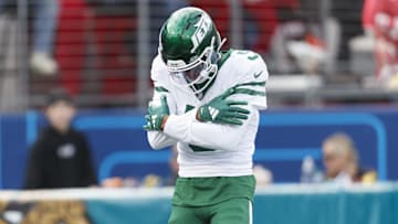 Dec 15, 2024; Jacksonville, Florida, USA; New York Jets wide receiver Garrett Wilson (5) celebrates a touchdown against the Jacksonville Jaguars during the first quarter at EverBank Stadium.