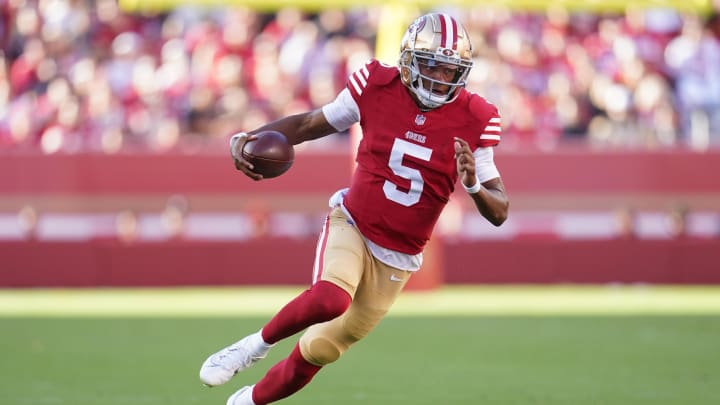 Aug 18, 2024; Santa Clara, California, USA; San Francisco 49ers quarterback Joshua Dobbs (5) runs for a first down against the New Orleans Saints in the second quarter at Levi's Stadium. Mandatory Credit: Cary Edmondson-USA TODAY Sports