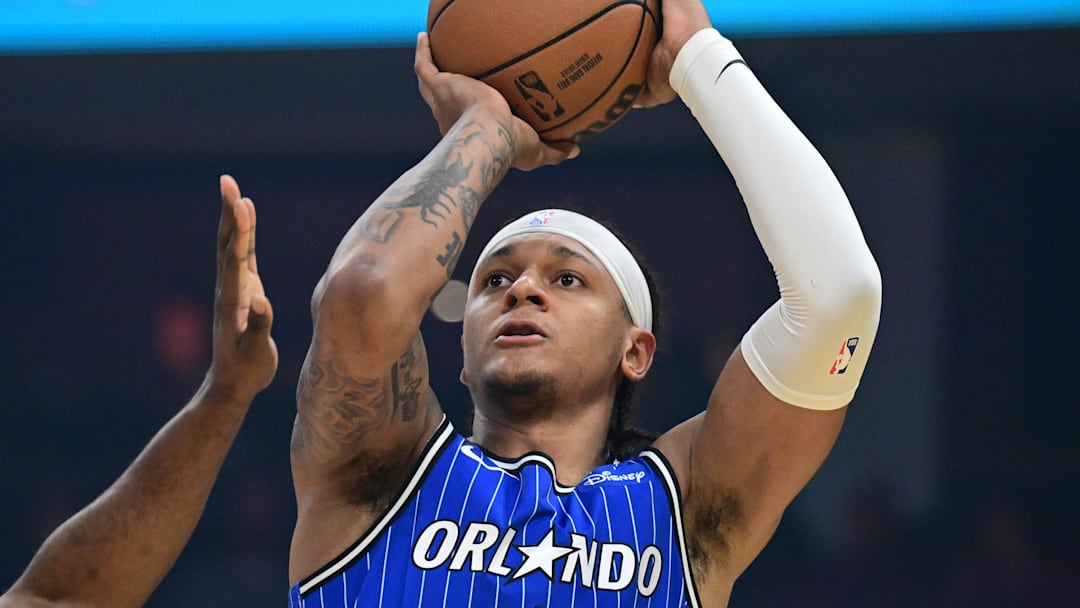 Mar 24, 2026; Cleveland, Ohio, USA; Orlando Magic forward Paolo Banchero (5) shoots against Cleveland Cavaliers guard James Harden (1) during the first half at Rocket Arena. Mandatory Credit: David Dermer-Imagn Images