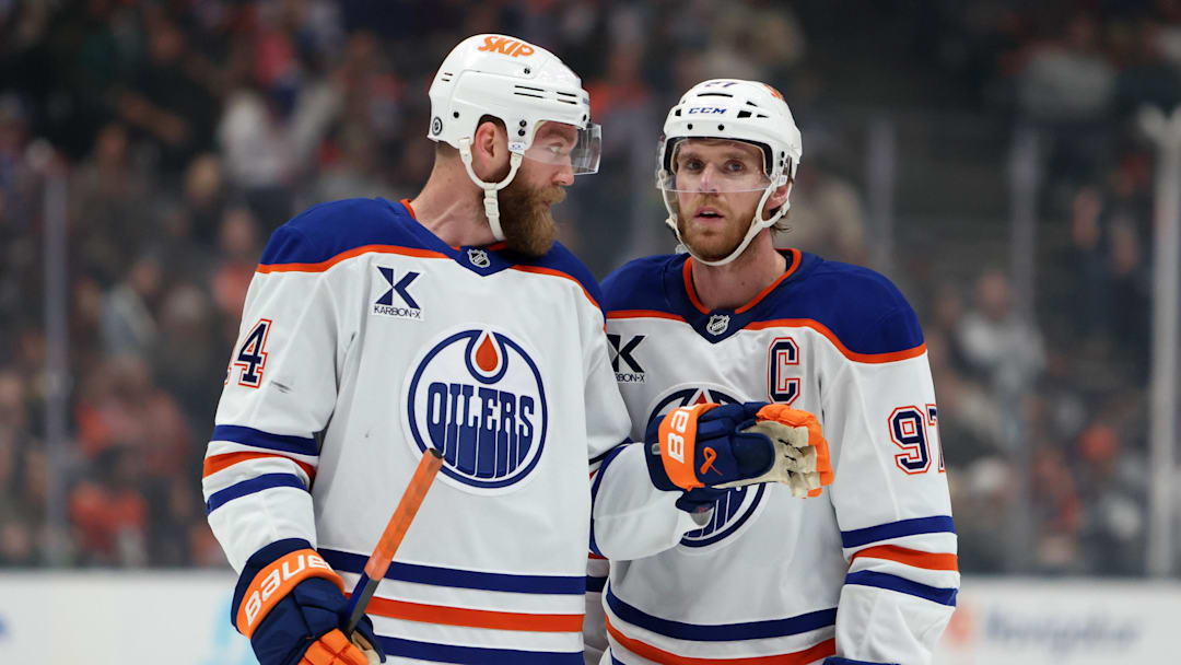 Edmonton Oilers center Connor McDavid (97) talks to defenseman Mattias Ekholm (14)