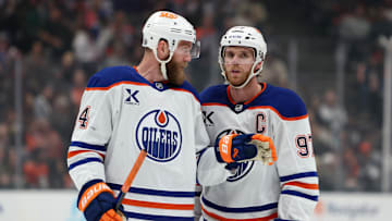 Edmonton Oilers center Connor McDavid (97) talks to defenseman Mattias Ekholm (14)