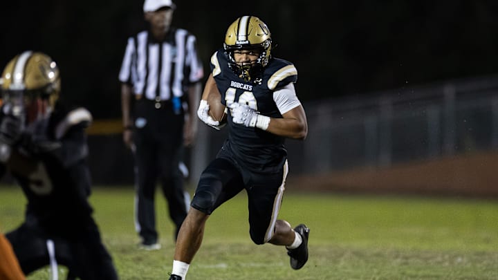 Buchholz Bobcats running back Justin Williams (13) rushes with the ball against the Tocoi Creek Toros during the first half at Citizens Field in Gainesville, FL on Monday, October 14, 2024. [Matt Pendleton/Gainesville Sun]
