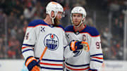 Dec 29, 2024; Anaheim, California, USA;  Edmonton Oilers center Connor McDavid (97) talks to defenseman Mattias Ekholm (14) during the first period against the Anaheim Ducks at Honda Center. Mandatory Credit: Kiyoshi Mio-Imagn Images