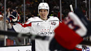Washington Capitals right wing Ryan Leonard smiles as he celebrates a goal by teammate center Dylan Strome.