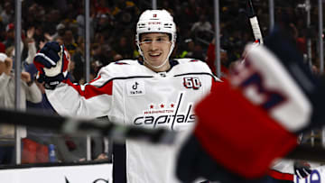 Washington Capitals right wing Ryan Leonard smiles as he celebrates a goal by teammate center Dylan Strome.