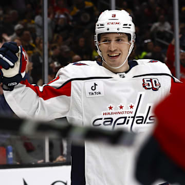 Washington Capitals right wing Ryan Leonard smiles as he celebrates a goal by teammate center Dylan Strome.
