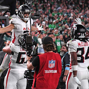 Atlanta Falcons wide receiver Drake London gets a lift from All-Pro guard Chris Lindstrom after scoring the game winner against the Philadelphia Eagles.