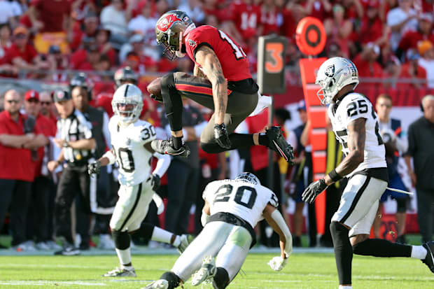  Tampa Bay Buccaneers wide receiver Mike Evans (13) jumps over Las Vegas Raiders safety Isaiah Pola-Mao 