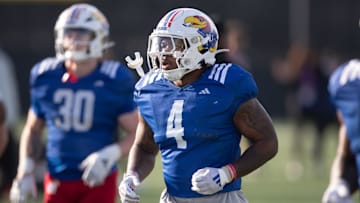 Kansas redshirt senior running back Leshon Williams (4) runs to positions during an outdoor practice on Thursday, March 27, 2025.