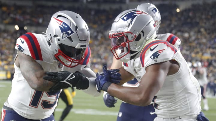 Dec 7, 2023; Pittsburgh, Pennsylvania, USA;  New England Patriots running back Ezekiel Elliott (15) celebrates with wide receiver JuJu Smith-Schuster (right) after Elliot scored a touchdown against the Pittsburgh Steelers during the first quarter at Acrisure Stadium. Mandatory Credit: Charles LeClaire-USA TODAY Sports