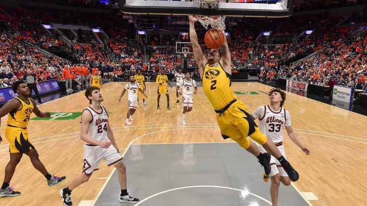 Dec 22, 2022; St. Louis, Missouri, USA;  Missouri Tigers guard Tre Gomillion (2) dunks as Illinois Fighting Illini forward Matthew Mayer (24) and forward Coleman Hawkins (33) look on during the second half at Enterprise Center. Mandatory Credit: Jeff Curry-USA TODAY Sports