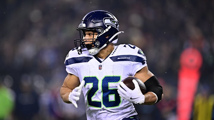 Dec 26, 2024; Chicago, Illinois, USA; Seattle Seahawks running back Zach Charbonnet (26) runs the ball against the Chicago Bears during the first quarter at Soldier Field. Dec 26, 2024; Chicago, Illinois, USA; Seattle Seahawks running back Zach Charbonnet (26) runs the ball against the Chicago Bears during the first quarter at Soldier Field.
