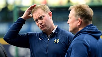 Oct 2, 2024; Milwaukee, Wisconsin, USA; Milwaukee Brewers general manager Matt Arnold talks to manager Matt Arnold before game two of the Wildcard round for the 2024 MLB Playoffs against the New York Mets at American Family Field. Mandatory Credit: Benny Sieu-Imagn Images