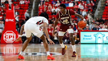 Feb 15, 2025; Raleigh, North Carolina, USA; Boston College Eagles guard Chas Kelley III (00) dribbles with the ball guarded by North Carolina State Wolfpack guard Jayden Taylor (8) during the second half of the game at Lenovo Center. Mandatory Credit: Jaylynn Nash-Imagn Images