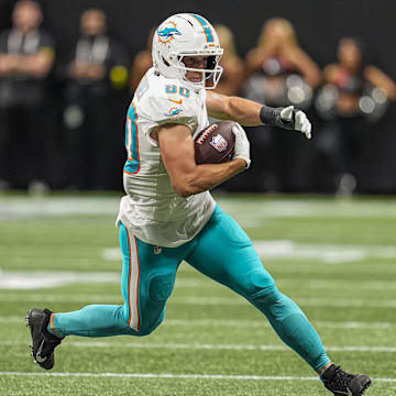 Miami Dolphins tight end Tanner Conner (80) runs against Atlanta Falcons linebacker JD Bertrand (40) during the second half at Mercedes-Benz Stadium.