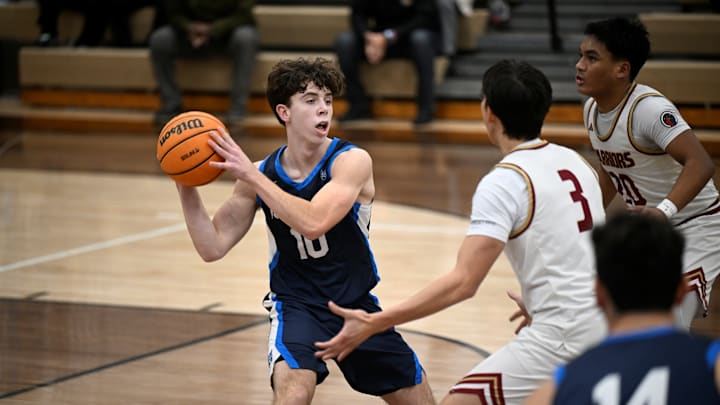 Milken's Grayson Coleman handles pressure from two Alemany defenders.