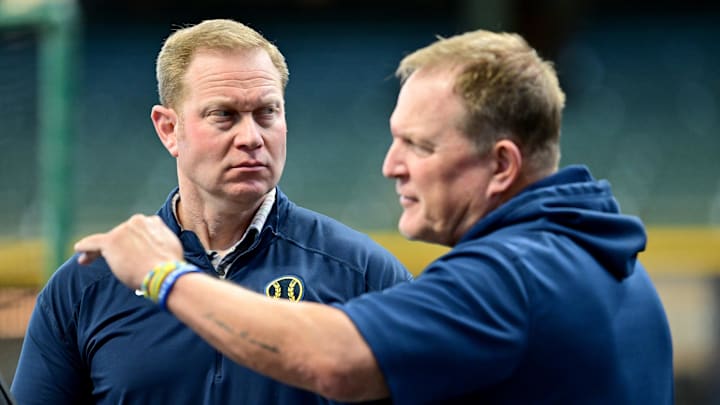 Oct 2, 2024; Milwaukee, Wisconsin, USA; Milwaukee Brewers general manager Matt Arnold talks to manager Matt Arnold before game two of the Wildcard round for the 2024 MLB Playoffs against the New York Mets at American Family Field. Mandatory Credit: Benny Sieu-Imagn Images
