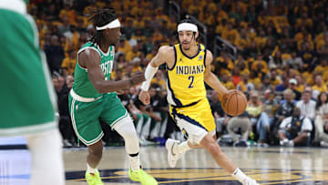 May 25, 2024; Indianapolis, Indiana, USA; Indiana Pacers guard Andrew Nembhard (2) controls the ball against Boston Celtics guard Jrue Holiday (4) during the first quarter of game three of the eastern conference finals in the 2024 NBA playoffs at Gainbridge Fieldhouse. Mandatory Credit: Trevor Ruszkowski-Imagn Images