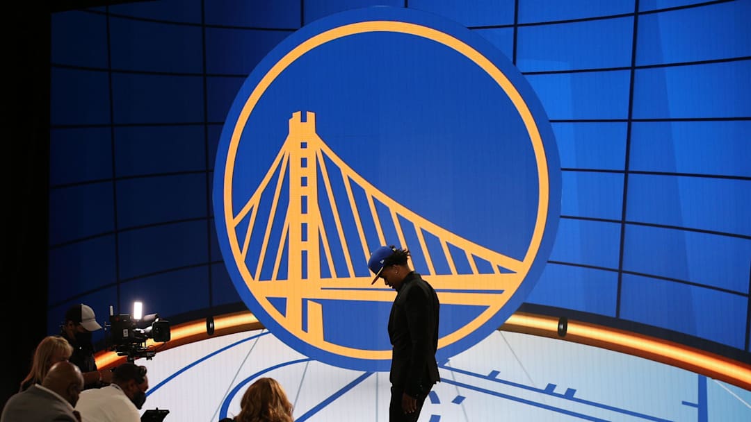 Jul 29, 2021; Brooklyn, New York, USA; Moses Moody (Arkansas) walks off the stage after being selected as the number fourteen overall pick by the Golden State Warriors in the first round of the 2021 NBA Draft at Barclays Center. Mandatory Credit: Brad Penner-Imagn Images