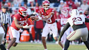 Nov 1, 2025; Fayetteville, Arkansas, USA; Arkansas Razorbacks quarterback Taylen Green (10) hands off to running back Braylen Russell (0) during the third quarter agains the Mississippi State Bulldogs at Donald W. Reynolds Razorback Stadium. Bulldogs won 38-35. Mandatory Credit: Nelson Chenault-Imagn Images