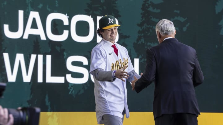 Jul 9, 2023; Seattle, Washington, USA; Oakland Athletics draft pick Jacob Wilson shakes hands with Rob Manfred during the first round of the MLB Draft at Lumen Field. Mandatory Credit: Stephen Brashear-USA TODAY Sports