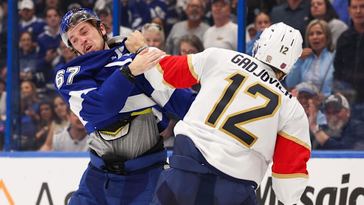 Oct 2, 2025; Tampa, Florida, USA; Tampa Bay Lightning defenseman Declan Carlile (67) and Florida Panthers left wing Jonah Gadjovich (12) exchange shoves in the second period at Benchmark International Arena. Mandatory Credit: Nathan Ray Seebeck-Imagn Images