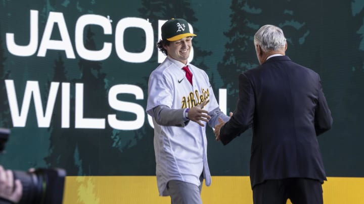 Jul 9, 2023; Seattle, Washington, USA; Oakland Athletics draft pick Jacob Wilson shakes hands with Rob Manfred during the first round of the MLB Draft at Lumen Field. Mandatory Credit: Stephen Brashear-USA TODAY Sports