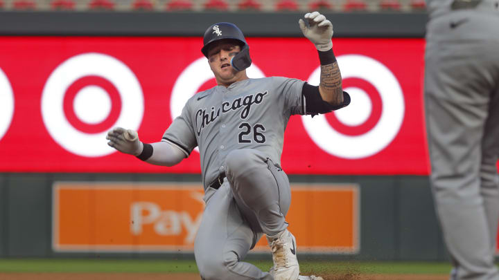 Aug 3, 2024; Minneapolis, Minnesota, USA; Chicago White Sox catcher Korey Lee (26) slides into third base with an RBI triple against the Minnesota Twins in the fifth inning at Target Field.