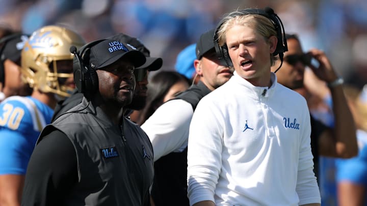 Oct 4, 2025; Pasadena, California, USA;  UCLA Bruins interim head coach Tim Skipper (left) and  new offensive coordinator Jerry Neuheisel (right) on the sideline during second half against the Penn State Nittany Lions at Rose Bowl. Mandatory Credit: Kiyoshi Mio-Imagn Images