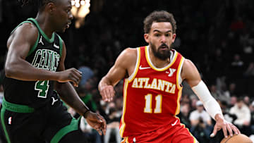 Jan 18, 2025; Boston, Massachusetts, USA; Atlanta Hawks guard Trae Young (11) drives to the basket against Boston Celtics guard Jrue Holiday (4) during the second quarter at the TD Garden. Mandatory Credit: Brian Fluharty-Imagn Images