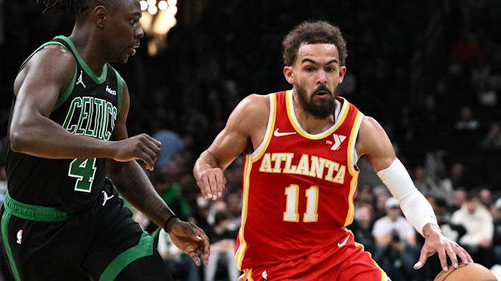 Jan 18, 2025; Boston, Massachusetts, USA; Atlanta Hawks guard Trae Young (11) drives to the basket against Boston Celtics guard Jrue Holiday (4) during the second quarter at the TD Garden. Mandatory Credit: Brian Fluharty-Imagn Images