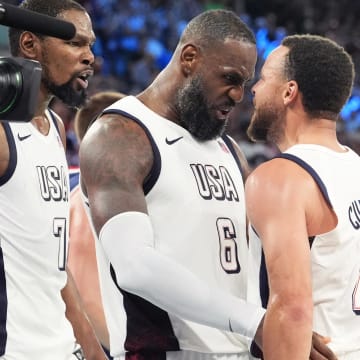 Aug 8, 2024; Paris, France; United States guard Kevin Durant (7), guard LeBron James (6) and shooting guard Stephen Curry (4) celebrate after the game against Serbia in a men's basketball semifinal game during the Paris 2024 Olympic Summer Games at Accor Arena. 