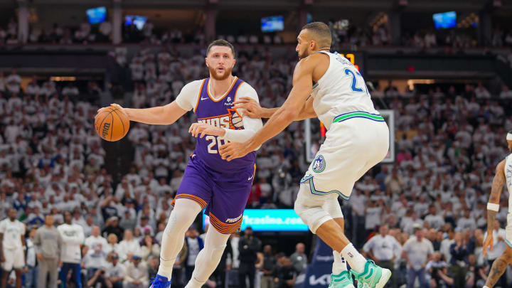 Apr 23, 2024; Minneapolis, Minnesota, USA; Phoenix Suns center Jusuf Nurkic (20) dribbles against Minnesota Timberwolves center Rudy Gobert (27) in the second quarter during game two of the first round for the 2024 NBA playoffs at Target Center. Mandatory Credit: Brad Rempel-USA TODAY Sports