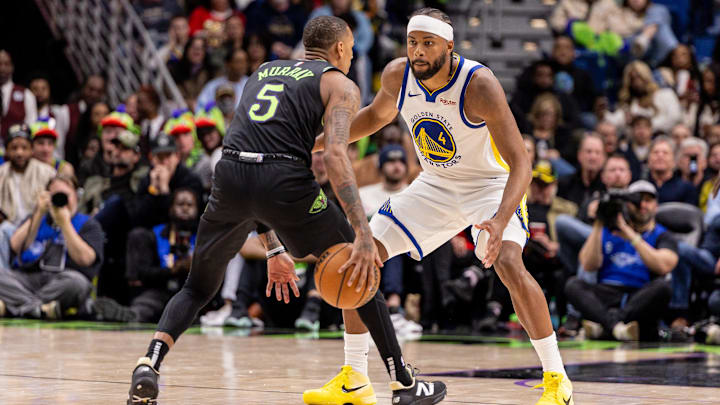 Feb 24, 2026; New Orleans, Louisiana, USA;  New Orleans Pelicans guard Dejounte Murray (5) dribbles against Golden State Warriors guard Moses Moody (4) during the second half at Smoothie King Center. Mandatory Credit: Stephen Lew-Imagn Images