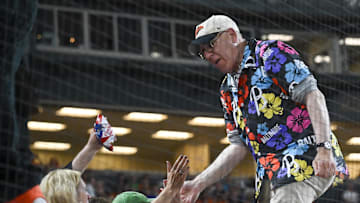 Jun 29, 2024; Baltimore, Maryland, USA;  Baltimore Orioles owner David Rubenstein high fives fans during the seventh inning stretch against the Texas Rangers at Oriole Park at Camden Yards. 