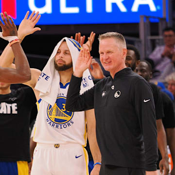 Golden State Warriors forward Jonathan Kuminga (00) high fives guard Stephen Curry (30) and head coach Steve Kerr as a time out is called against the Atlanta Hawks during the fourth quarter at Chase Center. Mandatory Credit: