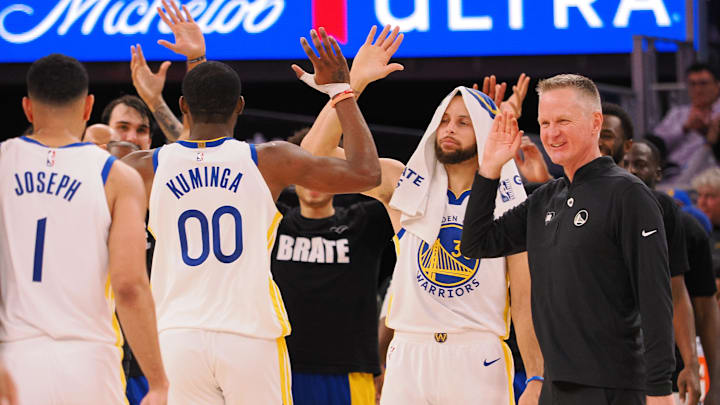 Golden State Warriors forward Jonathan Kuminga (00) high fives guard Stephen Curry (30) and head coach Steve Kerr as a time out is called against the Atlanta Hawks during the fourth quarter at Chase Center. Mandatory Credit: