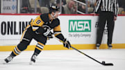 Feb 23, 2025; Pittsburgh, Pennsylvania, USA;  Pittsburgh Penguins left wing Michael Bunting (8) moves the puck against the New York Rangers during the second period at PPG Paints Arena. Mandatory Credit: Charles LeClaire-Imagn Images