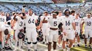 Oct 25, 2025; Chapel Hill, North Carolina, USA; Virginia Cavaliers players celebrate after winning the game in overtime at Kenan Stadium. Mandatory Credit: Bob Donnan-Imagn Images