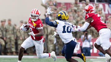 Nov 9, 2024; Bloomington, Indiana, USA; Indiana Hoosiers wide receiver Ke'Shawn Williams (5) runs with the ball while Michigan Wolverines defensive back Zeke Berry (10)  defends in the first quarter at Memorial Stadium. Mandatory Credit: Trevor Ruszkowski-Imagn Images
