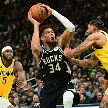 Apr 27, 2025; Milwaukee, Wisconsin, USA; Milwaukee Bucks forward Giannis Antetokounmpo (34) takes a shot against Indiana Pacers forward Obi Toppin (1) and forward Jarace Walker (5) in the third quarter during game four of first round for the 2024 NBA Playoffs at Fiserv Forum. Mandatory Credit: Benny Sieu-Imagn Images