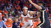 Mar 7, 2025; Champaign, Illinois, USA;  Illinois Fighting Illini guard Tre White (22) drives the ball against Purdue Boilermakers guard C.J. Cox (0) during the first half at State Farm Center. Mandatory Credit: Ron Johnson-Imagn Images
