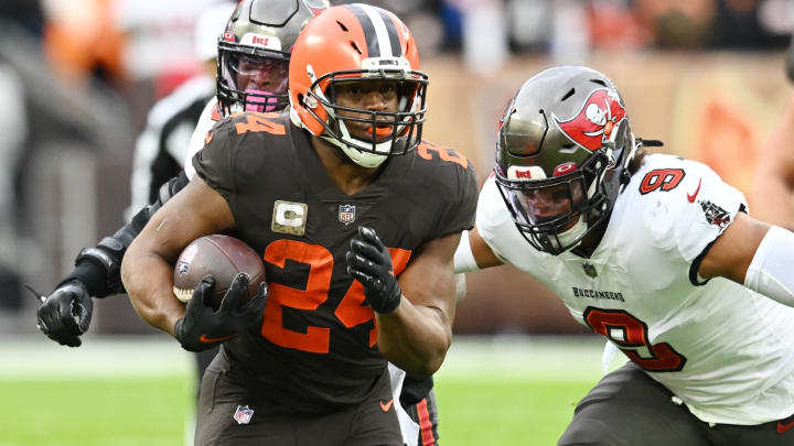 Nov 27, 2022; Cleveland, Ohio, USA; Cleveland Browns running back Nick Chubb (24) runs with the ball as Tampa Bay Buccaneers linebacker Joe Tryon-Shoyinka (9) pursues during the first half at FirstEnergy Stadium. Mandatory Credit: Ken Blaze-USA TODAY Sports