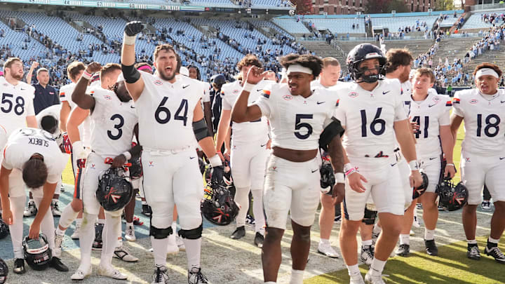 Oct 25, 2025; Chapel Hill, North Carolina, USA; Virginia Cavaliers players celebrate after winning the game in overtime at Kenan Stadium. Mandatory Credit: Bob Donnan-Imagn Images