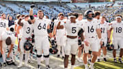 Oct 25, 2025; Chapel Hill, North Carolina, USA; Virginia Cavaliers players celebrate after winning the game in overtime at Kenan Stadium. Mandatory Credit: Bob Donnan-Imagn Images