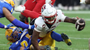 Oct 25, 2025; Pittsburgh, Pennsylvania, USA;  North Carolina State Wolfpack quarterback CJ Bailey (11) reaches for his fumble against the Pittsburgh Panthers during the third quarter at Acrisure Stadium. Mandatory Credit: Charles LeClaire-Imagn Images