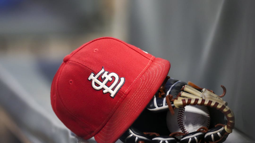 Sep 17, 2018; Atlanta, GA, USA; Detailed view of a St. Louis Cardinals hat and glove in the dugout against the Atlanta Braves in the first inning at SunTrust Park. Mandatory Credit: Brett Davis-Imagn Images
