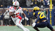 Ohio State Buckeyes running back Bo Jackson (25) runs past Michigan Wolverines defensive back Jyaire Hill (20) during the NCAA football game at Michigan Stadium in Ann Arbor, Mich. on Nov. 29, 2025. Ohio State won 27-9.